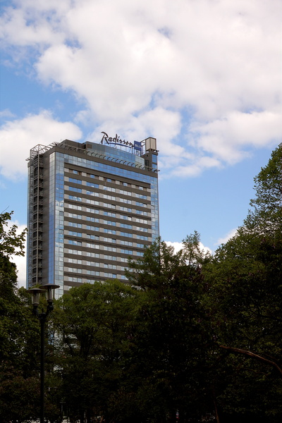 Modern Skyscraper with Partial Signage and Overcast Skies