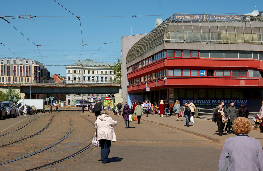 Urban Scene: A Riga Street with Pedestrians, Tram Track, and Architectural Landmarks