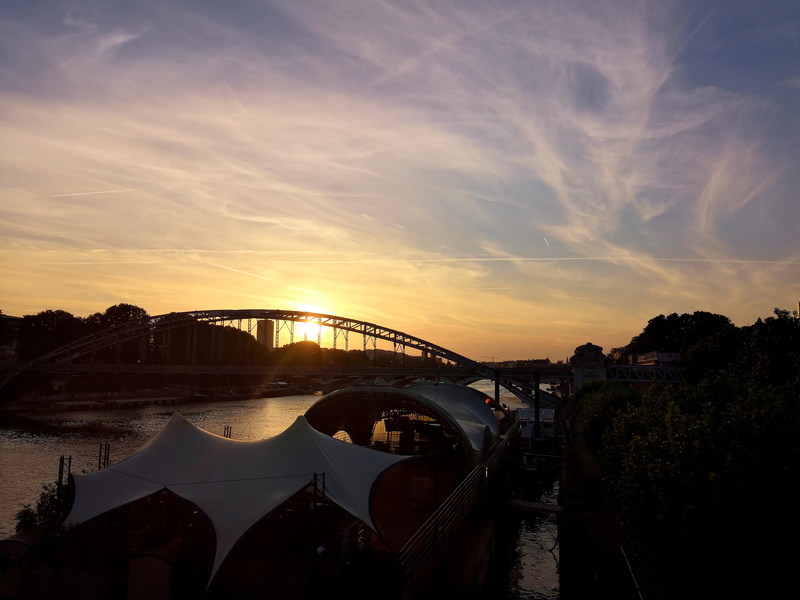 River Sunset Scene with Bridge and Overpass Silhouettes