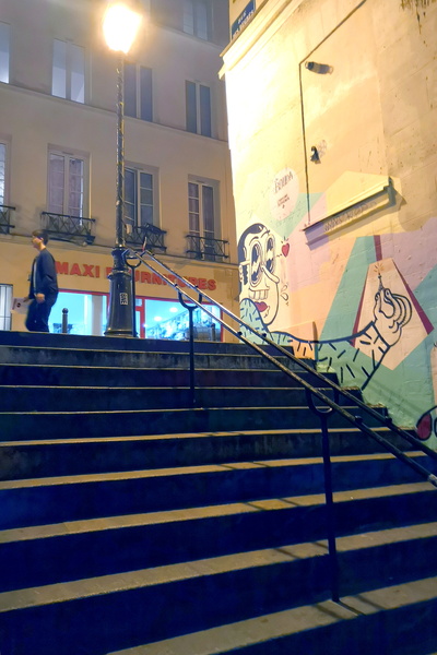 Murals on an urban staircase at night