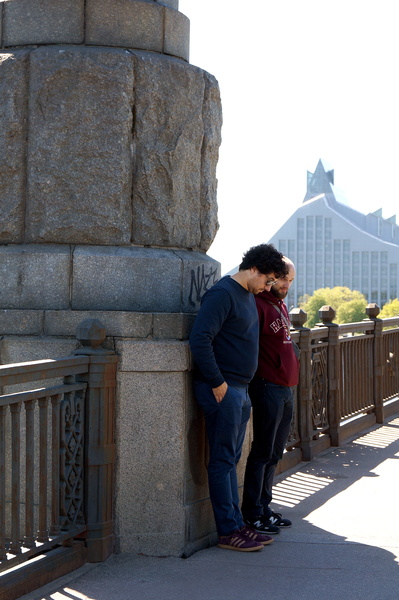 Two Friends Leaning on a Bridge in Riga, Latvia