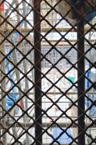 Construction Scene Viewed from Behind Bars