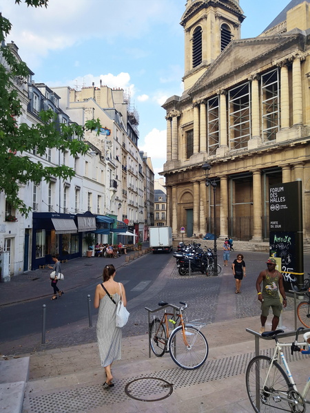 Urban Scene: A Woman Walks Past a Church in Paris, France