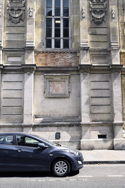 City Life in Paris, France: A Modern Car Parked Outside a Historic Building