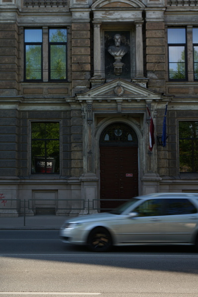 Classical Building with Red Flag on Riga Street, Europe