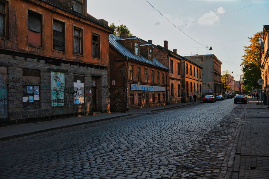 Narrow, cobblestone street with old European buildings