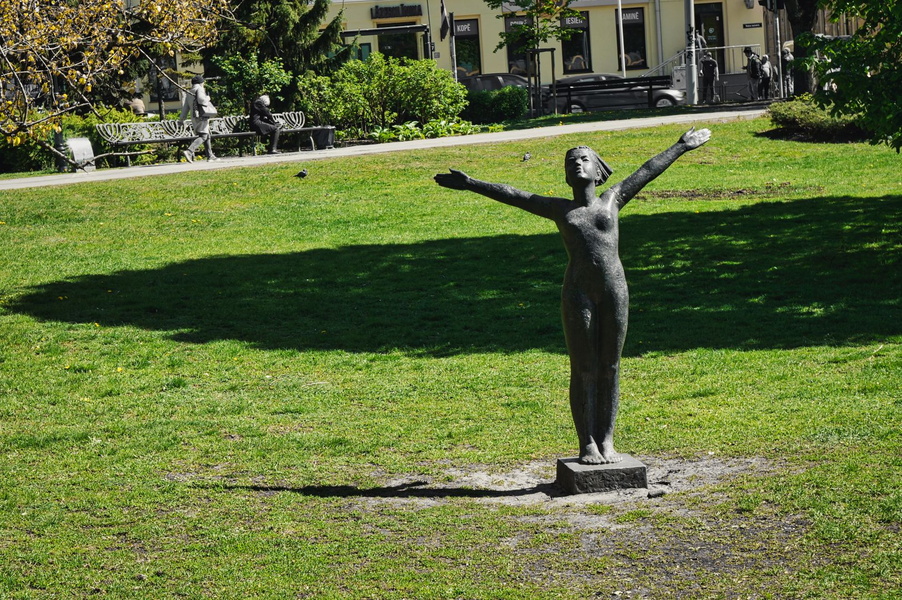 Victory in the Park: A Statue of a Woman Embracing Success
