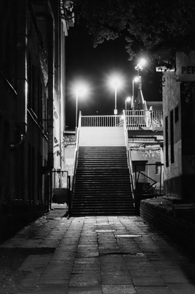 Lonely Night in Vilnius: A Desolate Stairway Illuminated by a Lone Streetlight