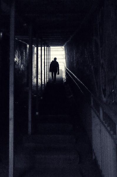 Lone Figure in an Abandoned Hallway
