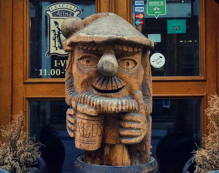 Enthusiastic Dwarf Statue at a Tavern Entrance in Vilnius, Lithuania