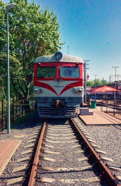 Vintage Red Train on Tracks at a Train Station