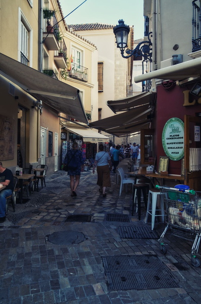 Lively Malaga Sidewalk on a Sunny Day