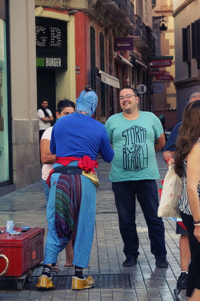 Joyful Street Entertainment: A Clown Performs in Malaga, Spain
