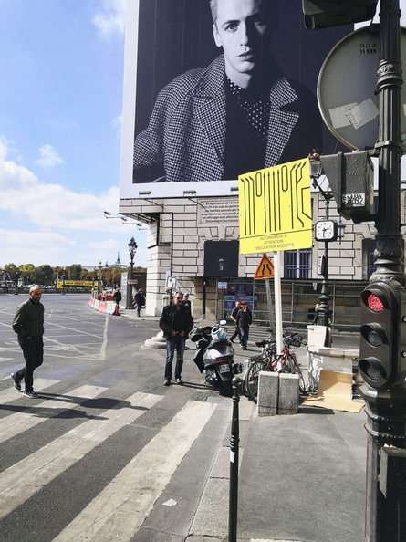 Bustling City Life: A Billboard Adjacent to a Bus Stop on a Rainy Day