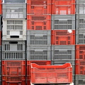 Stacked Cages of Various Sizes and Colors in a Rustic Setting