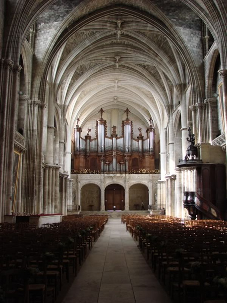 Gothic Cathedral Interior: An Empty Church Nave with Stained Glass and Organ Pipes