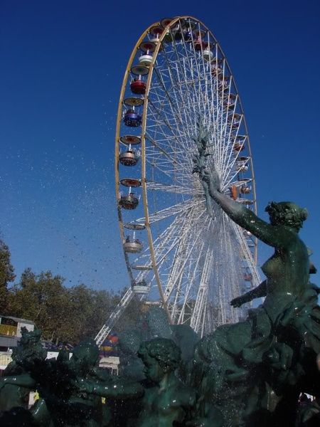 Ferris Wheel with Fountains and Statues in a Park