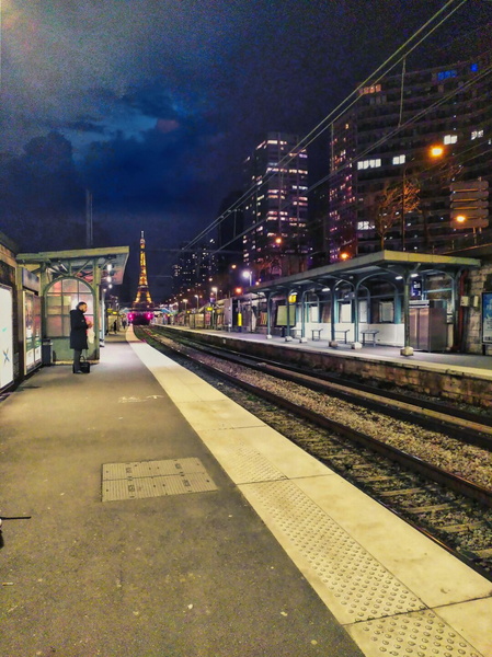 An Empty Paris Train Station at Night with the Eiffel Tower in the Background