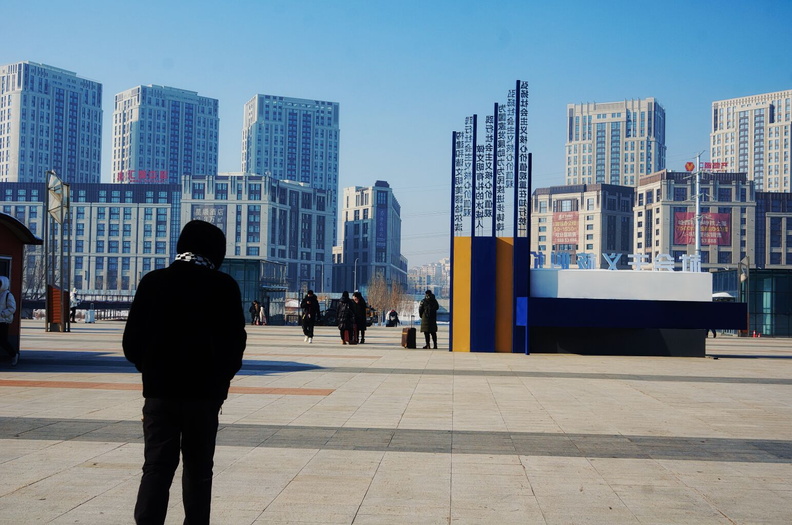 Urban Landscape: A Man in a Plaza Overlooking City Buildings