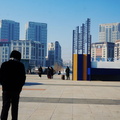 Urban Landscape: A Man in a Plaza Overlooking City Buildings