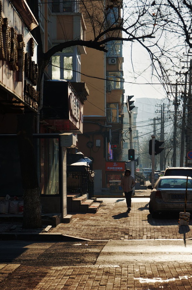 A Lone Figure on an Autumn Day in a Harbin Cityscape