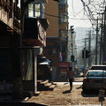 A Lone Figure on an Autumn Day in a Harbin Cityscape