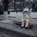 A Space Suit Sculpture Enjoys a Bench on a Snowy Day in Harbin, China