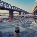 Harbin's Winter Wonderland: A Frozen River and a Pedestrian Bridge