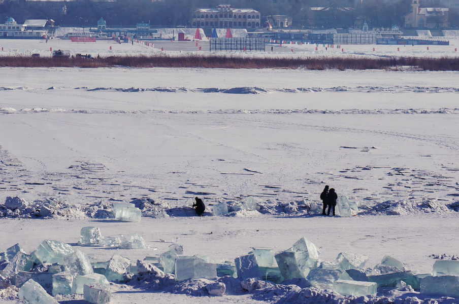 Harbin Winter Festival: A Frozen Scene of People Walking in a River