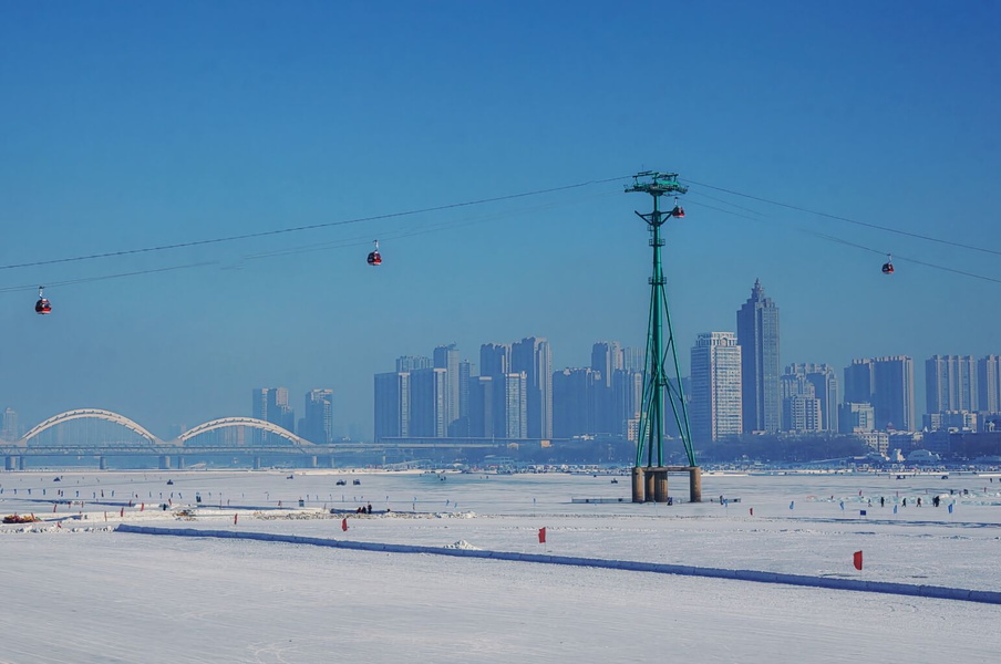 Harbin Winter Scene: City Skyline with a River and Ski Lift