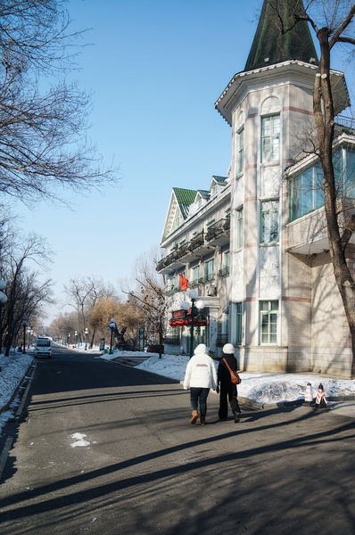 A Winter's Day in Harbin, China - People Walking Along a Snowy Street