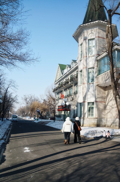 A Winter's Day in Harbin, China - People Walking Along a Snowy Street