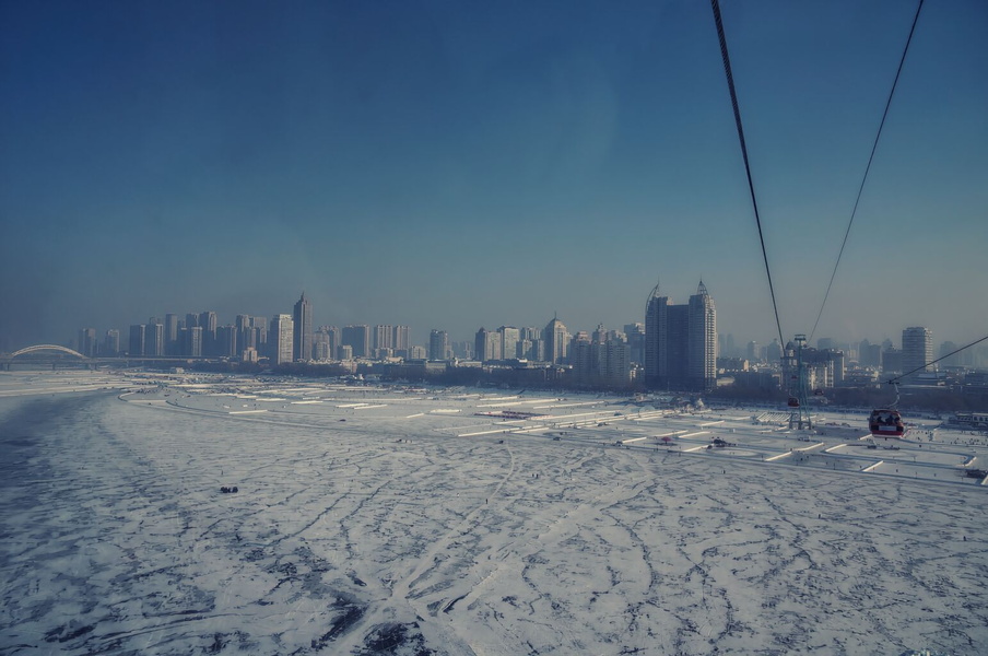 Winter Harbin: City Skyline by Frozen River