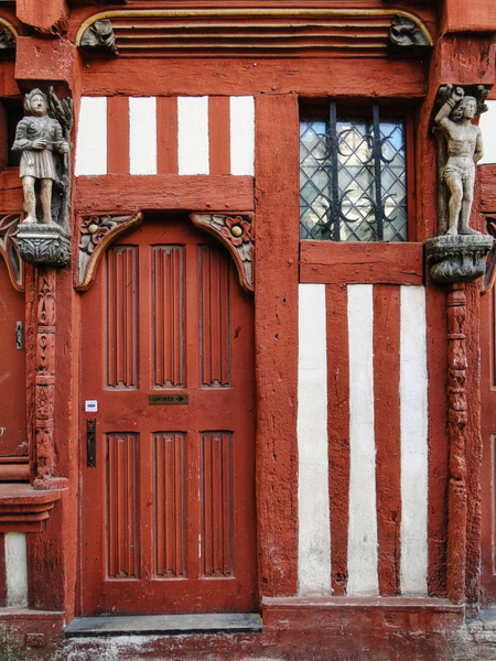 Historic Doorway with Striped Shutters and Gargoyles