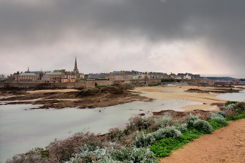 A serene coastal town under a dramatic sky