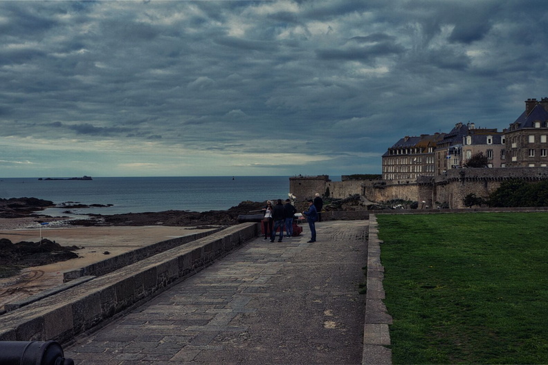 Tranquil Seaside Scene: Saint-Malo Harbor with a Stone Walkway and Coastal View