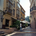 A Sunny Day in Malaga, Spain: Narrow Alley Leading to a Historic Building