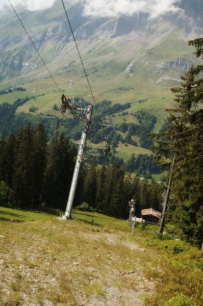 Serene Alpine Landscape: A Ski Lift with Hiking Trails in a Picturesque Town