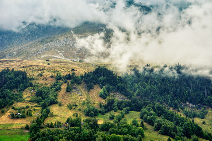 Foggy Mountain Landscape with a Village Nestled in the Valley