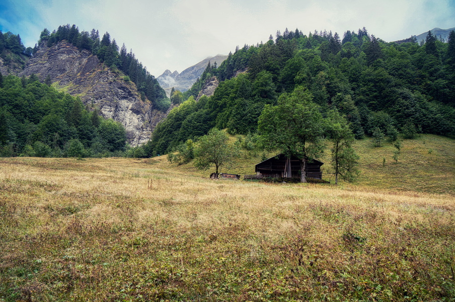 Serene Mountain Valley with Wooden Cabins
