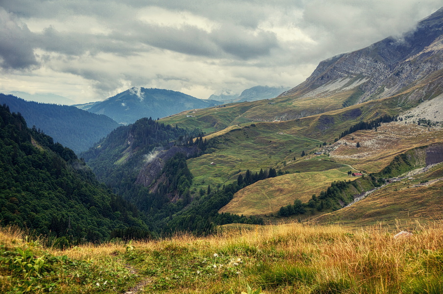 Serene Mountainous Valley under a Cloudy Sky