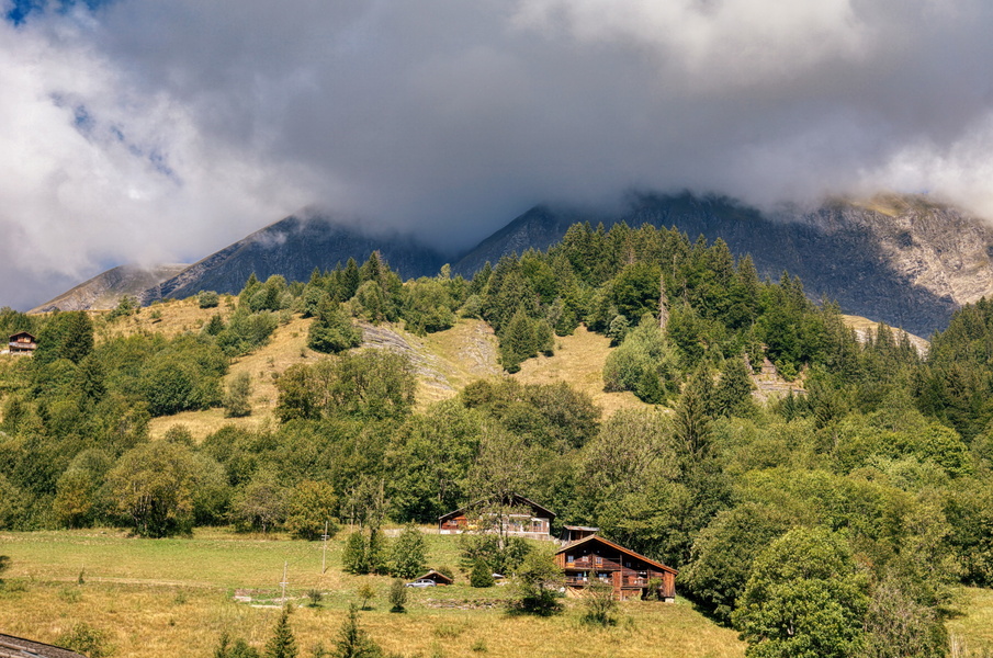 Misty Mountain Range with Rustic Farmhouse