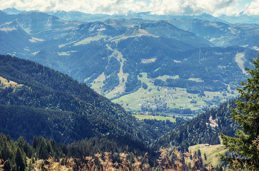 Vast Alpine Mountain Range with Vibrant Pastures