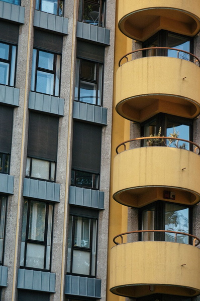 Modern Apartment Complex with Balconies and City Skyline