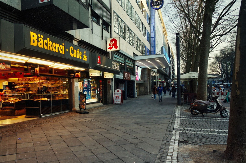 Köln's Night-Time Buzz: A Café and Bakery on a European City Street