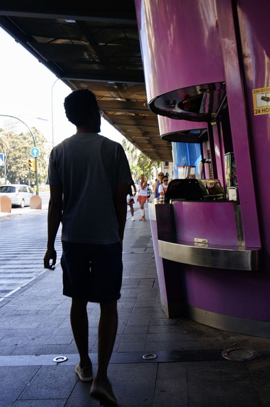 A solitary figure navigates a bustling European street