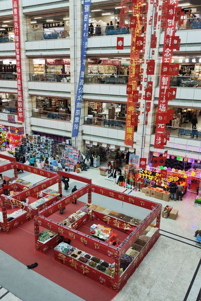 Vibrant Chinese Mall with Red Decorations and Lively Shoppers