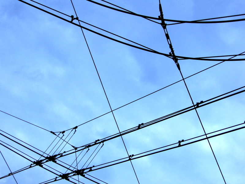 Overhead Power Grid against a Blue Sky Backdrop