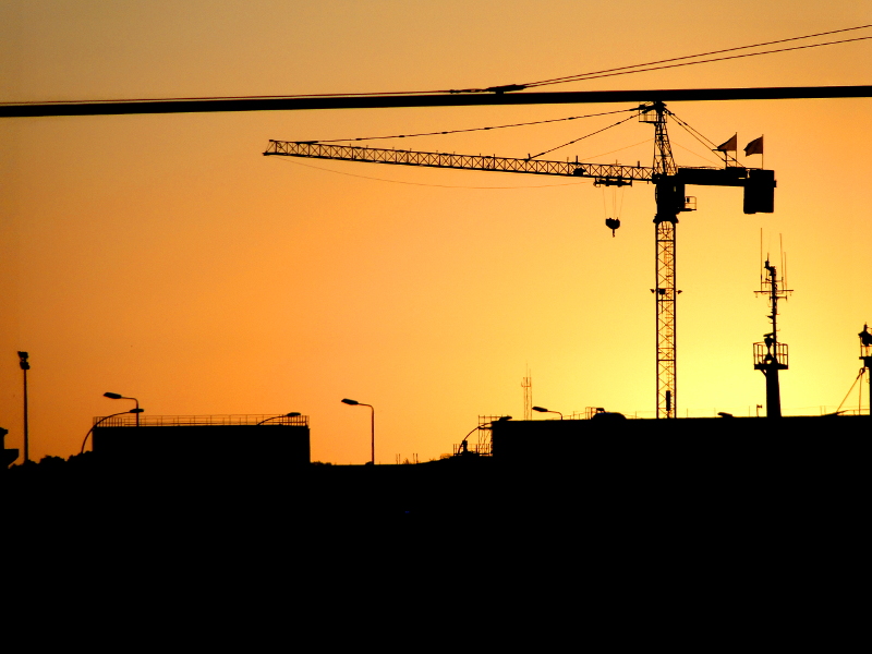 Sunset Silhouette with Construction Crane