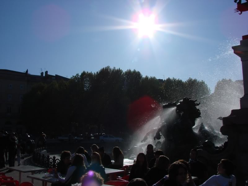 Sunlit Park Square with Fountain and Crowd